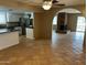 Spacious living room adjacent to kitchen featuring tile floors and natural light at 8601 E Berridge Ln, Scottsdale, AZ 85250