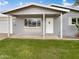 Charming home featuring a covered front porch, grey brick, and well-maintained lawn at 901 W 16Th St, Tempe, AZ 85281