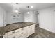 Bright kitchen featuring a granite island, tile flooring, and glass doors to the backyard at 901 W 16Th St, Tempe, AZ 85281