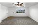 Spacious living room with a neutral carpet, ceiling fan, and large window to let natural light in at 901 W 16Th St, Tempe, AZ 85281