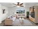 Bright living room with stylish sofas, a modern ceiling fan, and a large window with neighborhood views at 901 W 16Th St, Tempe, AZ 85281