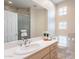 Bright bathroom featuring a large vanity with plenty of drawers, a sink, and an enclosed glass shower at 9113 N 116Th Way, Scottsdale, AZ 85259