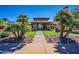 Beautiful clubhouse entrance with lush landscaping and a welcoming pathway at 9113 N 116Th Way, Scottsdale, AZ 85259