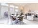 Open dining area with large windows, a fireplace, and a view into the living room at 9113 N 116Th Way, Scottsdale, AZ 85259