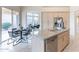 Kitchen island with a sink, complemented by a dining area and access to the outdoors at 9113 N 116Th Way, Scottsdale, AZ 85259