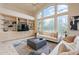 Bright living room with large windows, built-in shelving, and comfortable seating arrangement at 9113 N 116Th Way, Scottsdale, AZ 85259