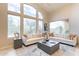 Bright and airy living room with floor-to-ceiling windows and comfortable seating at 9113 N 116Th Way, Scottsdale, AZ 85259