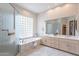 Well-lit main bathroom with a large soaking tub, glass enclosed shower, and a double sink vanity at 9113 N 116Th Way, Scottsdale, AZ 85259