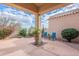 Covered patio with a neutral-toned concrete floor and bright blue chairs at 9113 N 116Th Way, Scottsdale, AZ 85259