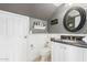 Charming bathroom with white wainscoting, granite countertop, and decorative mirror at 9116 W Acoma Dr, Peoria, AZ 85381