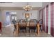 Spacious dining room with modern chandelier, wood table, and light wood flooring at 9116 W Acoma Dr, Peoria, AZ 85381