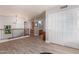 Bright hallway featuring hardwood floors, bathroom, closet and an abundance of natural light at 9116 W Acoma Dr, Peoria, AZ 85381