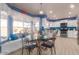 Bright kitchen featuring white cabinetry, stainless steel appliances, blue backsplash, and a cozy breakfast nook at 9116 W Acoma Dr, Peoria, AZ 85381