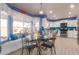 Eat-in kitchen featuring white cabinetry, stainless steel appliances, and a blue accent wall at 9116 W Acoma Dr, Peoria, AZ 85381