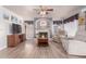 Cozy living room featuring a fireplace, ceiling fan, and neutral color palette at 9116 W Acoma Dr, Peoria, AZ 85381