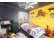 Unique bedroom with colorful walls, ceiling fan, and natural lighting at 11234 W Roma Ave, Phoenix, AZ 85037