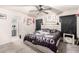 The bedroom features a fun decorative theme, a modern ceiling fan, and a connected bathroom at 11234 W Roma Ave, Phoenix, AZ 85037