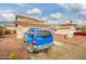 Two story home with a tile roof, two car garage and blue SUV parked out front at 11234 W Roma Ave, Phoenix, AZ 85037