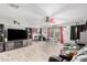 The living room offers an open layout, large TV, tile floors, and access to the backyard at 11234 W Roma Ave, Phoenix, AZ 85037