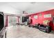 Spacious living room features tile flooring, a ceiling fan, and access to the backyard at 11234 W Roma Ave, Phoenix, AZ 85037