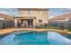 Backyard featuring a swimming pool with safety fence, artificial turf, and covered patio at 11234 W Roma Ave, Phoenix, AZ 85037