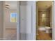 A neutral bathroom is shown with tan tile and a glass shower door at 13035 N 34Th St # 7, Phoenix, AZ 85032