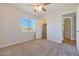 A carpeted bedroom includes a walk-in closet and window with blinds at 13035 N 34Th St # 7, Phoenix, AZ 85032