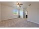 The spacious bedroom includes a ceiling fan and a desert view at 13035 N 34Th St # 7, Phoenix, AZ 85032