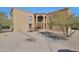 Inviting condo exterior with desert landscaping, an arched entryway, and stair access to upper units at 13035 N 34Th St # 7, Phoenix, AZ 85032