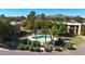 Inviting community pool surrounded by mature palm trees, lush landscaping, and providing a serene retreat for residents at 13035 N 34Th St # 7, Phoenix, AZ 85032