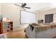 Living room with hardwood floors, ceiling fan, and neutral paint at 1501 S River Dr, Tempe, AZ 85281