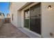Backyard view showcasing the sliding glass door to the patio, a gate, and a stucco wall at 15610 S 181St Dr, Goodyear, AZ 85338