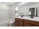 The bathroom features a tub and shower combo and double sink vanity with black fixtures at 15610 S 181St Dr, Goodyear, AZ 85338