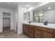 Bathroom featuring double sinks with granite countertops and a walk-in shower with glass door at 15610 S 181St Dr, Goodyear, AZ 85338