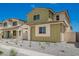 A charming two-story home with a light green facade, low-maintenance landscaping, and a welcoming walkway at 15610 S 181St Dr, Goodyear, AZ 85338