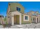 A charming two-story home with light green siding, a welcoming porch, and low-maintenance landscaping at 15610 S 181St Dr, Goodyear, AZ 85338