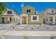 Charming two-story home with a vibrant green exterior and well-maintained, low-water landscaping at 15610 S 181St Dr, Goodyear, AZ 85338