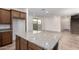 Bright kitchen boasts a granite countertop island and seamless access to the outdoor area at 15610 S 181St Dr, Goodyear, AZ 85338