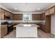 Spacious kitchen features stainless appliances, granite counters and a center island for easy meal prep at 15610 S 181St Dr, Goodyear, AZ 85338