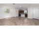 Bright and airy living space with tile flooring, recessed lighting, and a view of the kitchen and front door at 15610 S 181St Dr, Goodyear, AZ 85338