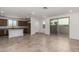 Open-concept living area featuring tile floors, stainless appliances, a kitchen island, and a sliding glass door at 15610 S 181St Dr, Goodyear, AZ 85338