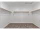 A walk-in closet featuring carpeted floor and shelving that spans the walls at 15610 S 181St Dr, Goodyear, AZ 85338