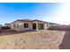 Expansive backyard with stucco fence and covered patio, ready for personalization and outdoor living at 15846 W Bronco Trl, Surprise, AZ 85387