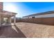 Spacious backyard with covered patio and block wall, perfect for outdoor entertaining and relaxation at 15846 W Bronco Trl, Surprise, AZ 85387
