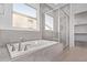 Bathroom featuring a soaking tub and walk-in shower with glass enclosure at 15846 W Bronco Trl, Surprise, AZ 85387
