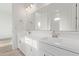 Bathroom featuring double sinks and a large mirror at 15846 W Bronco Trl, Surprise, AZ 85387