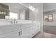 Bright bathroom featuring double sinks and a large mirror at 15846 W Bronco Trl, Surprise, AZ 85387