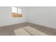 Bedroom with neutral carpet and a bright window providing natural light at 15846 W Bronco Trl, Surprise, AZ 85387