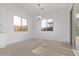 Bright dining area with large windows and a modern chandelier at 15846 W Bronco Trl, Surprise, AZ 85387