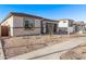 Single-story home with low-maintenance desert landscaping, showcasing its simple elegance at 15846 W Bronco Trl, Surprise, AZ 85387